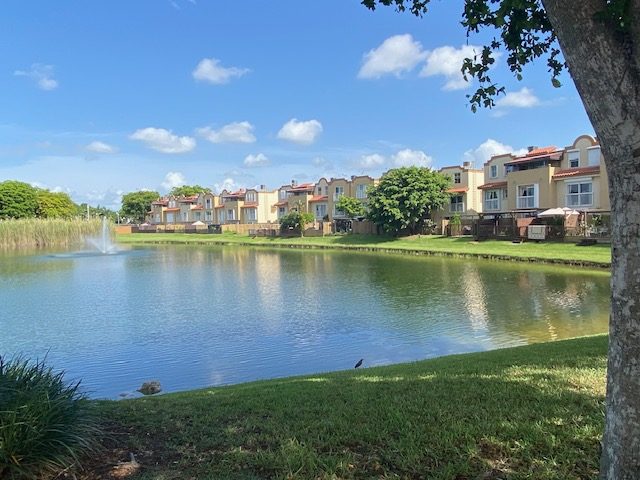 Townhomes overlooking a lake at Coral Pointe